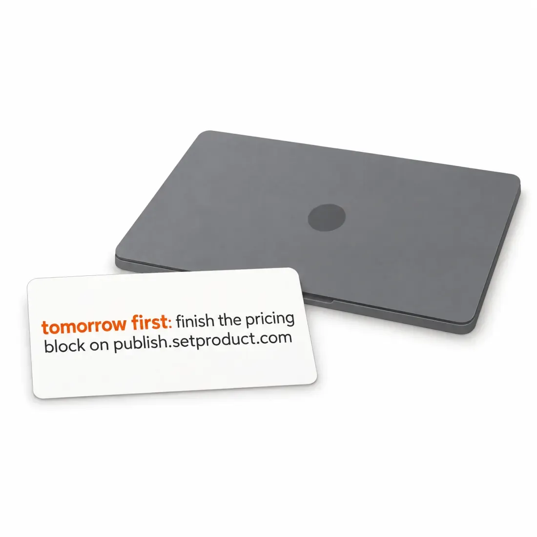 A note card reading tomorrow first, finish the pricing block on publish.setproduct.com, next to a closed laptop