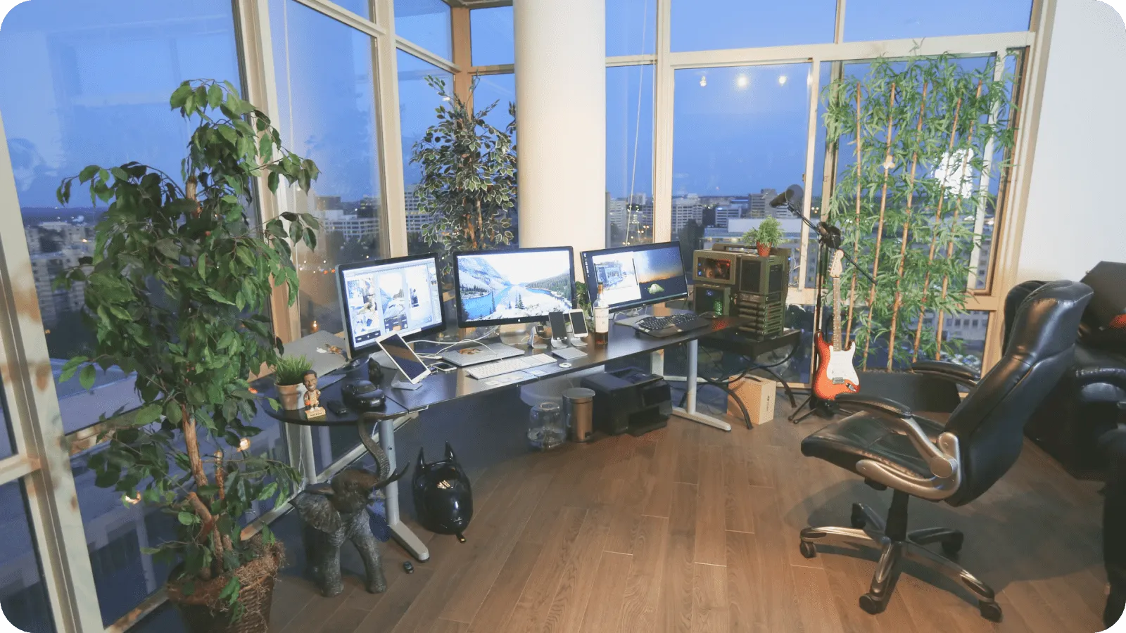 A tidy desk with a comfortable chair and a sit-stand desk for remote work